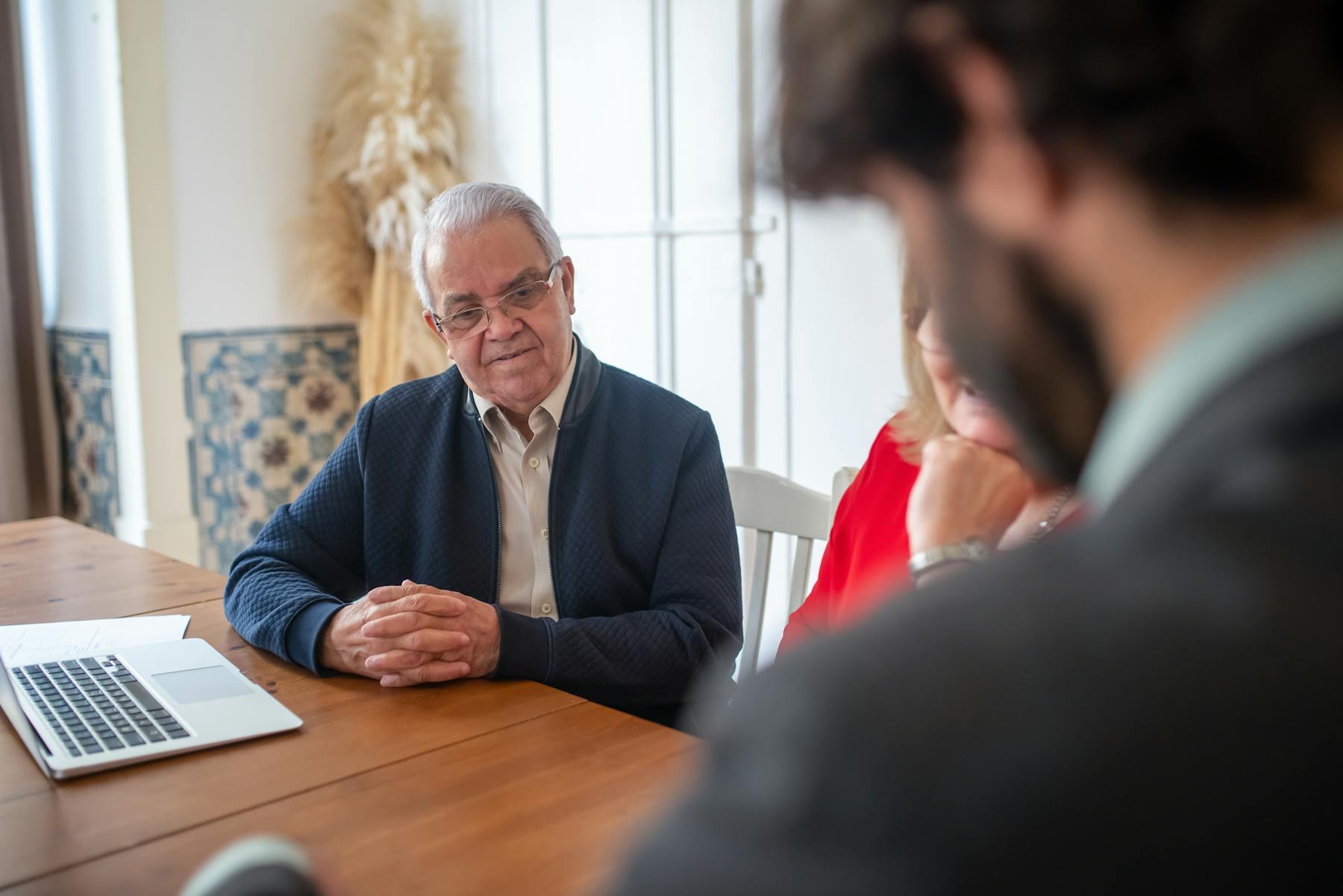 Accounting advisor reviewing client financial reports across a meeting table