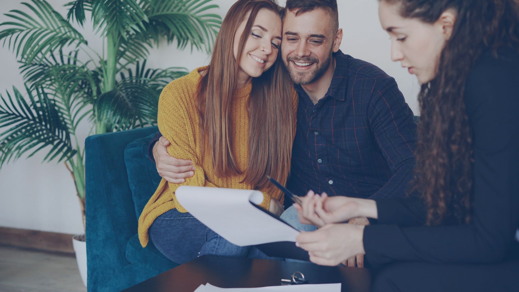 Advisor and prospective clients smiling during a discovery conversation