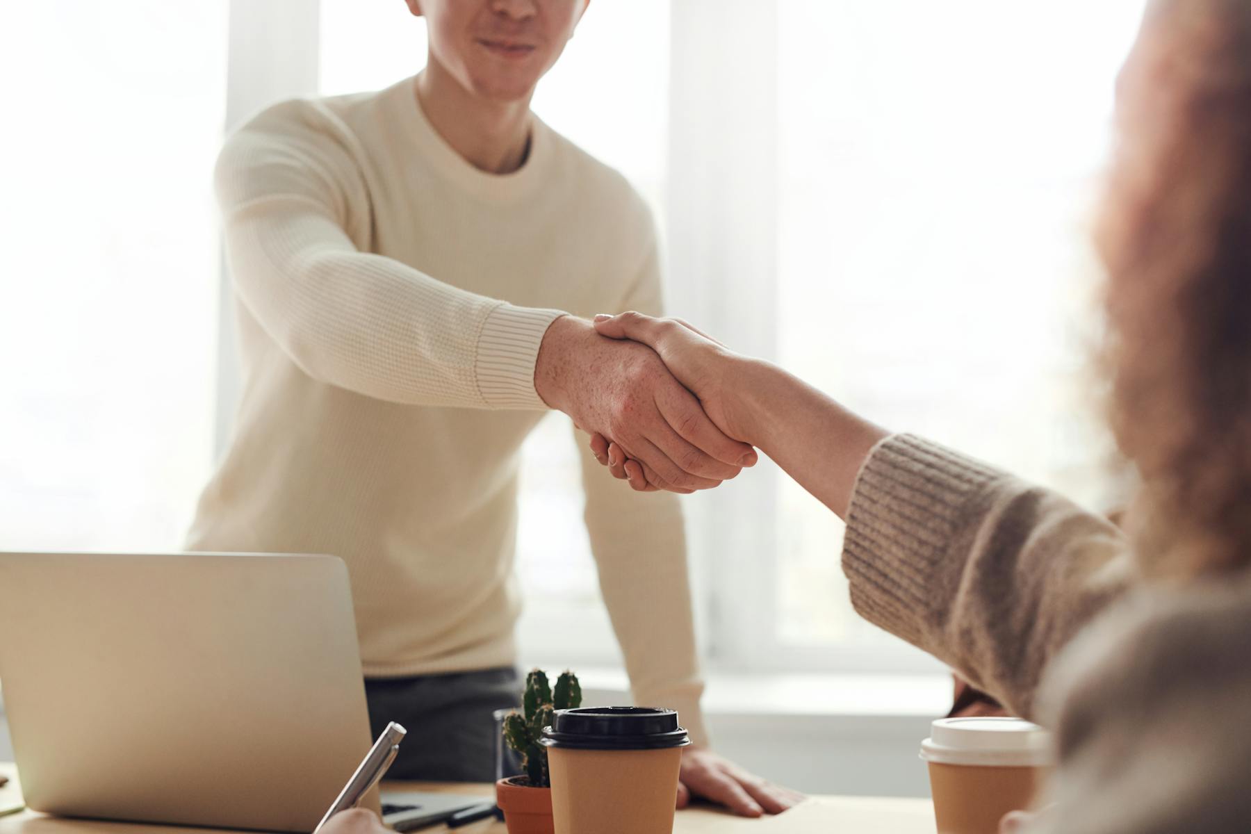 Client and advisor shaking hands at the start of a professional services engagement