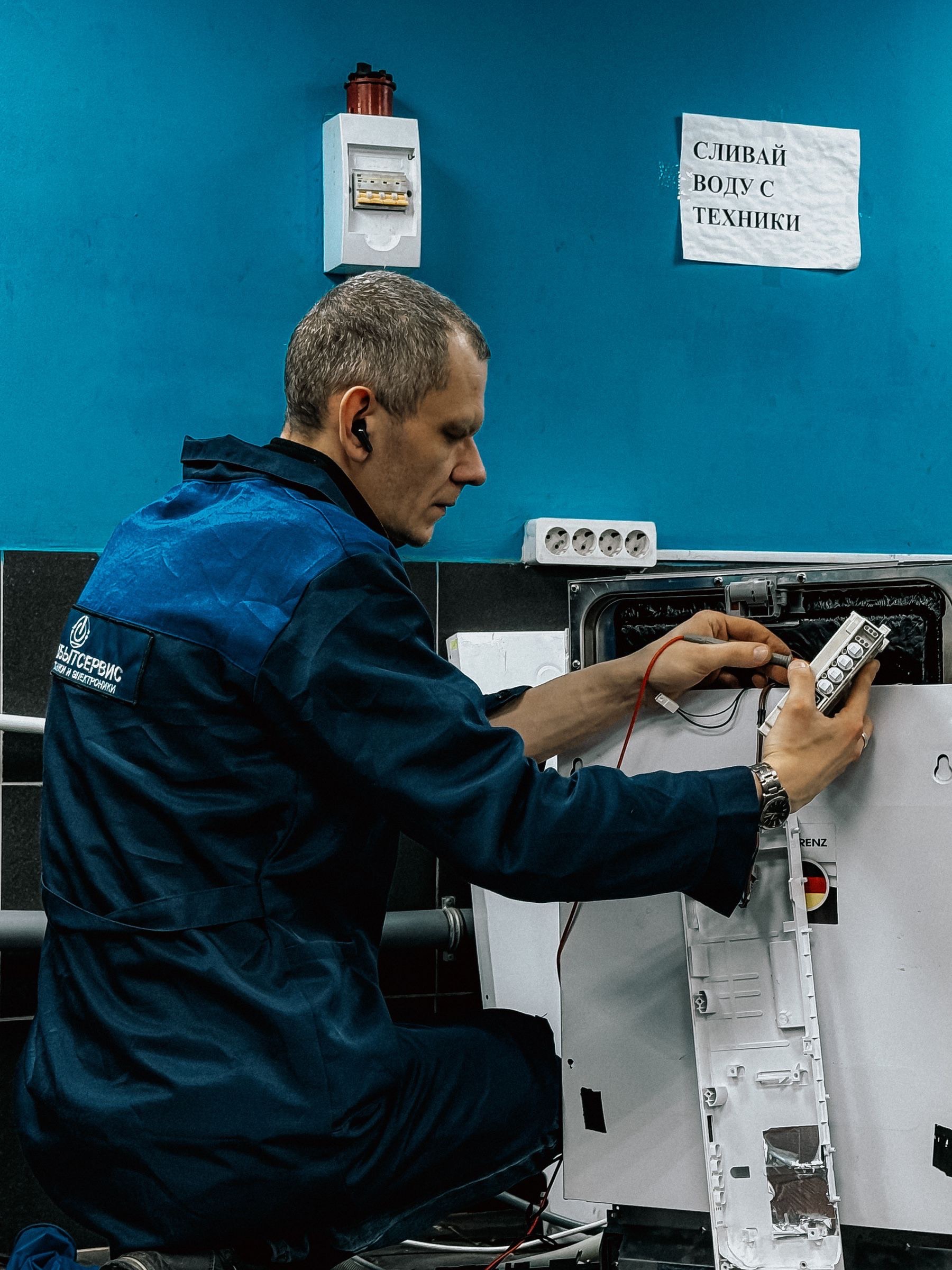 Service technician testing parts at a workshop bench before the next job